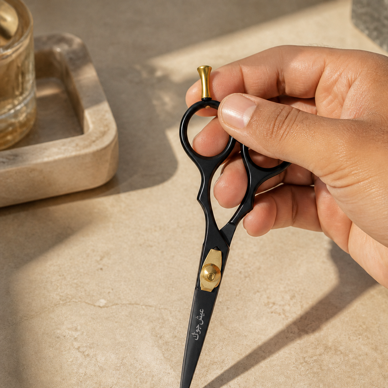 A hand lifting closed black and gold beard and moustache scissors