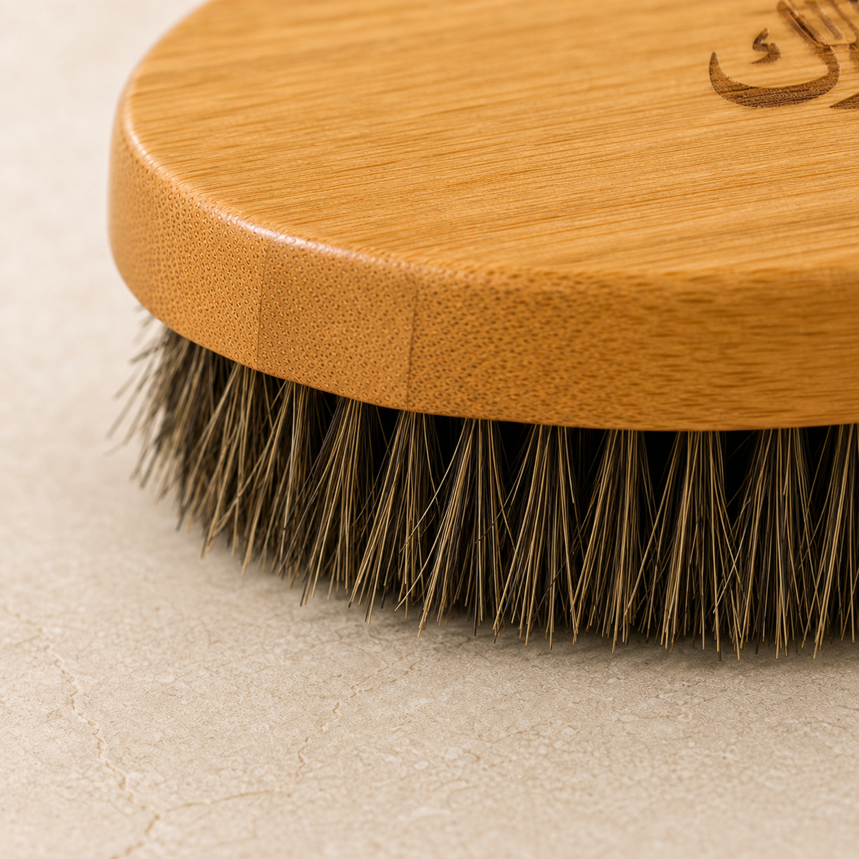 Close view of bamboo grain, engraved branding, and natural horse-hair bristles