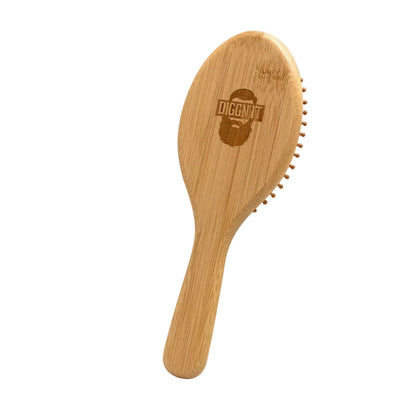 Rear of the Eco-Friendly Bamboo Hair Brush showing the engraved Diggn'It face mark