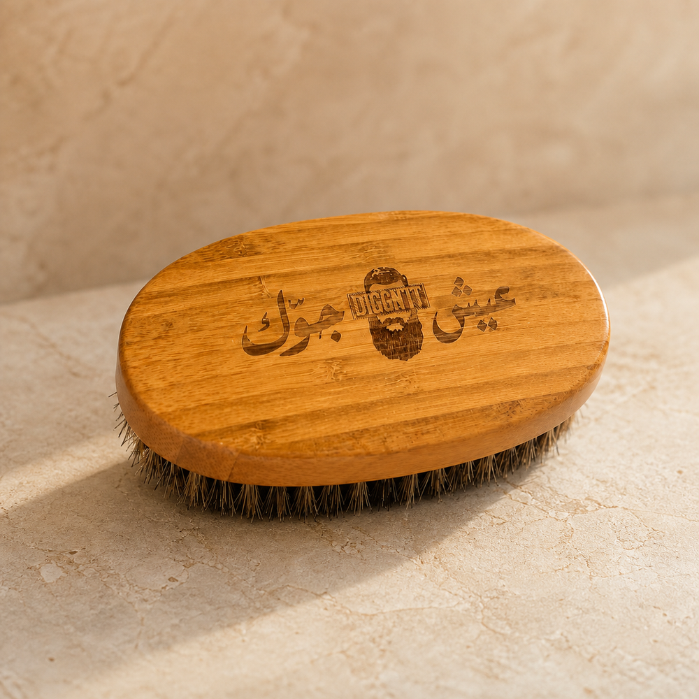Diggn'It Bamboo Beard Brush on a warm ivory mineral surface