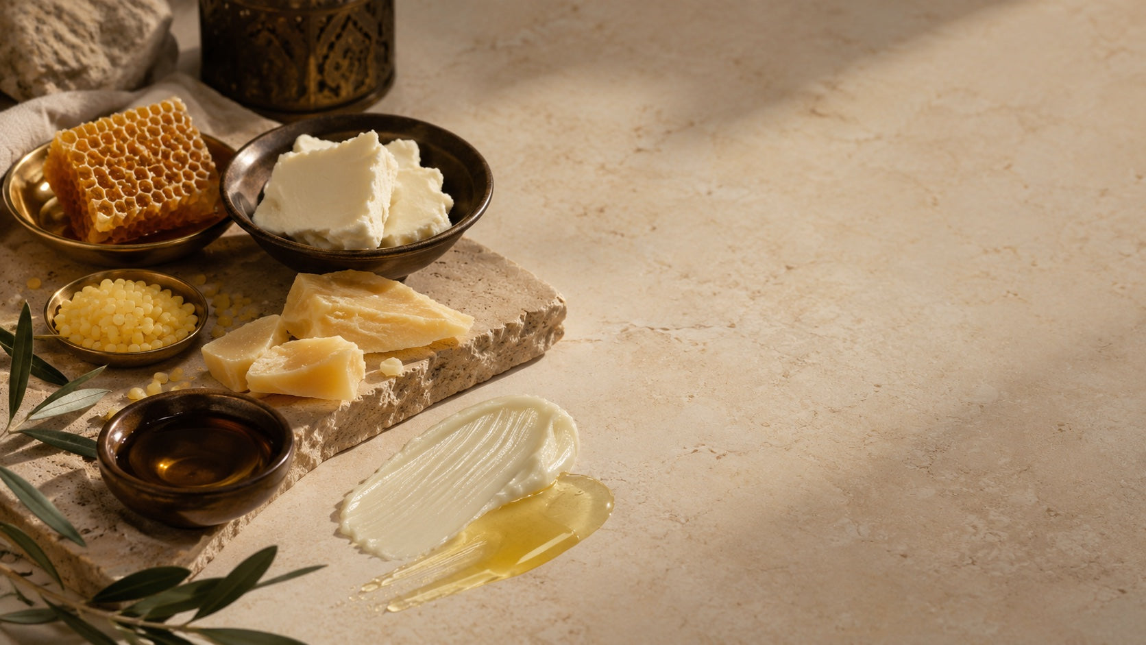 Beeswax, shea butter, and balm texture on a stone surface