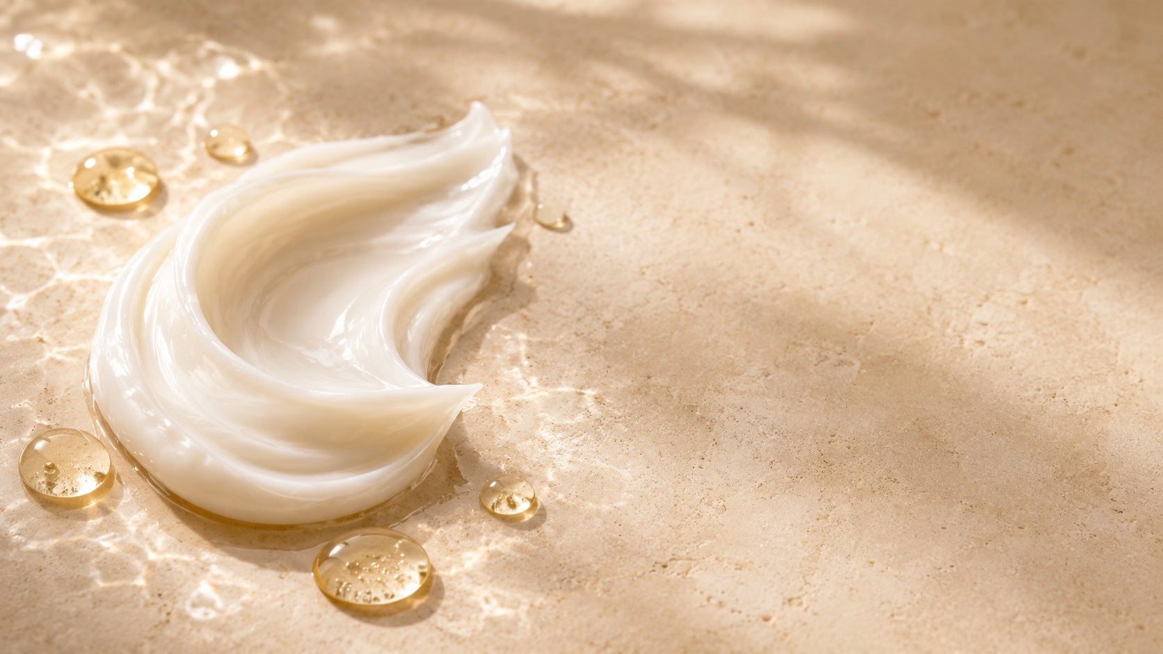 Glossy conditioner texture with golden moisture droplets on stone