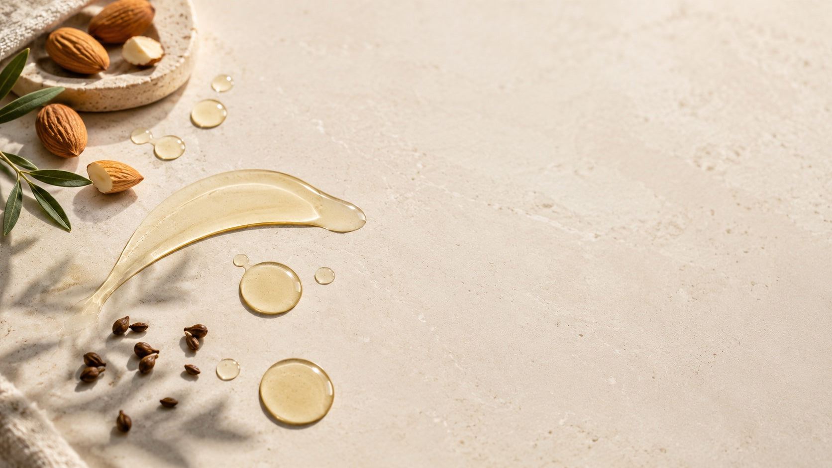 Light oil with almond and grape seed on a stone surface